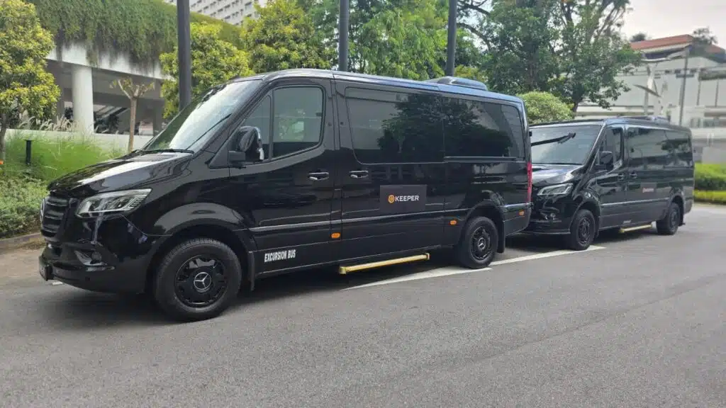 Two black luxury passenger vans for marina bay cruise centre transport and pickup guide group transfers